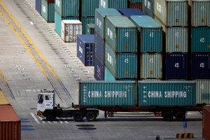 A container truck drives past the container area at the Yangshan Deep Water Port, part of the newly announced Shanghai Free Trade Zone, south of Shanghai